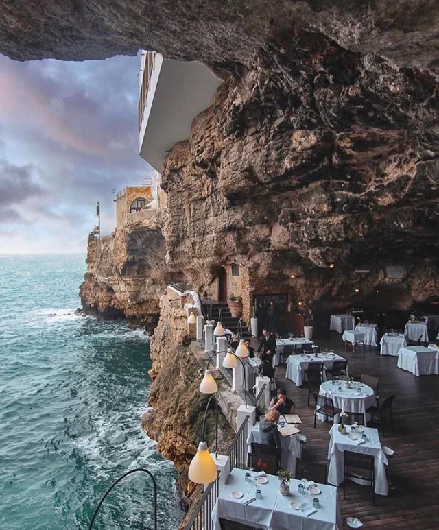 Terrace table set for two overlooking the Amalfi coast at golden hour